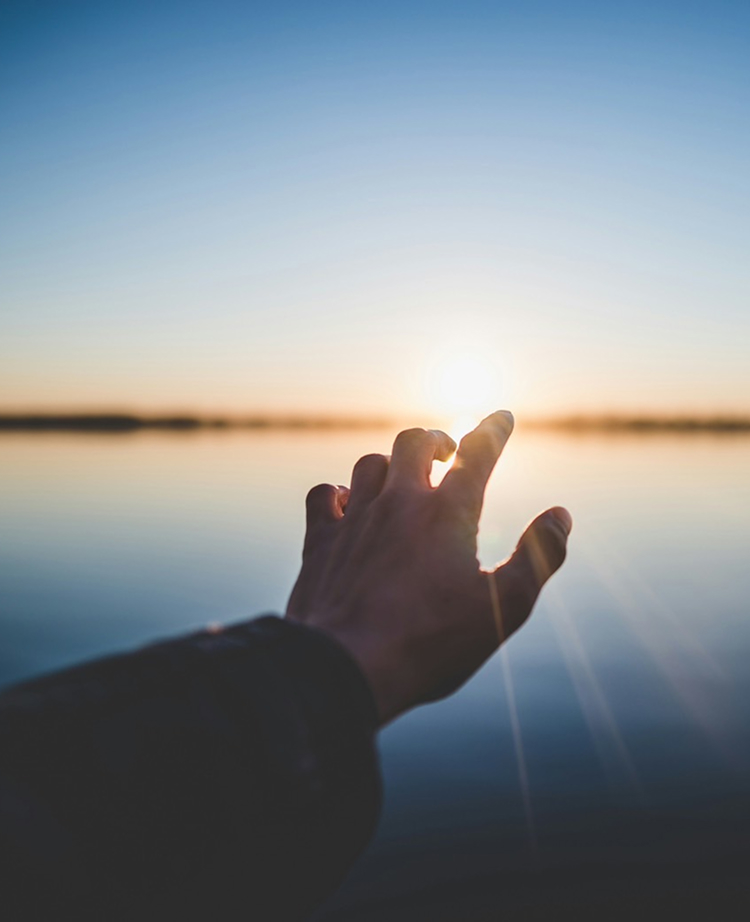 朝日に手を伸ばす様子